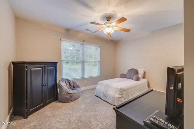 bedroom with light colored carpet, baseboards, ceiling fan, and visible vents