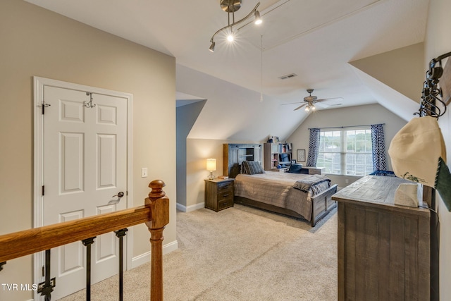 bedroom featuring a ceiling fan, visible vents, vaulted ceiling, baseboards, and light carpet