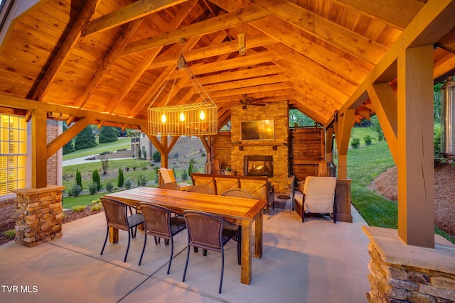view of patio / terrace featuring a gazebo, an outdoor living space with a fireplace, and outdoor dining space