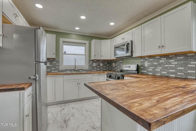 954 Maple St, Kingsport, TN 37660 - kitchen featuring stainless steel appliances, light marble finish floors, wooden counters, a peninsula, and recessed lighting