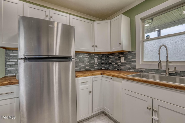 954 Maple St, Kingsport, TN 37660 - kitchen with freestanding refrigerator, butcher block counters, backsplash, and white cabinets