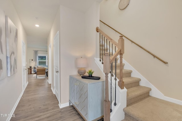 stairs featuring baseboards, recessed lighting, and wood finished floors