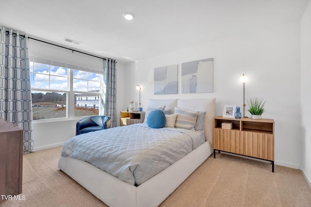 bedroom featuring baseboards, carpet flooring, and visible vents