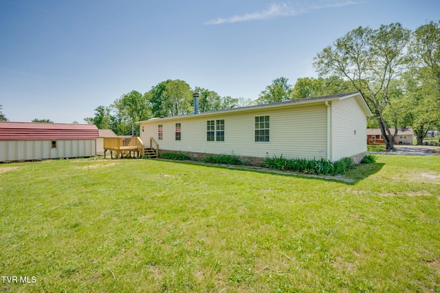 back of property featuring a yard and a deck