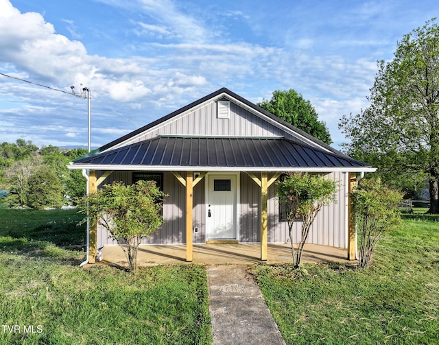 view of front of property featuring board and batten siding, a porch, and metal roof