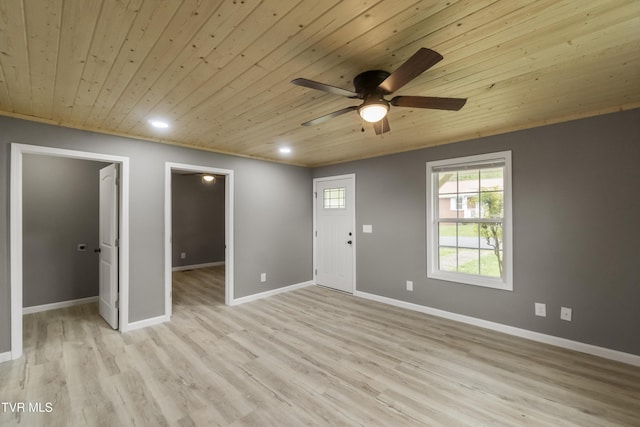 interior space with light wood-style floors, a ceiling fan, wood ceiling, and baseboards