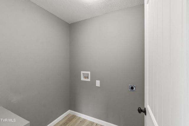 washroom featuring laundry area, electric dryer hookup, baseboards, hookup for a washing machine, and light wood-style floors