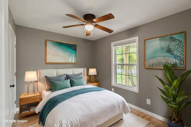 bedroom with baseboards, ceiling fan, and wood finished floors