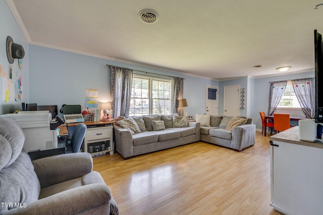 living area with visible vents, ornamental molding, and light wood-style floors