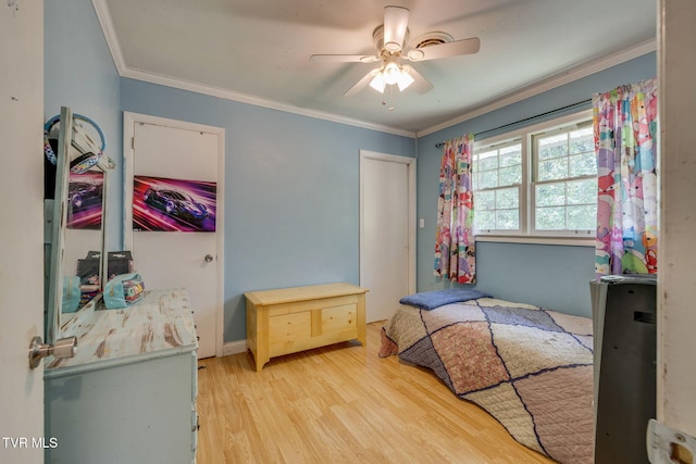 bedroom featuring a ceiling fan, ornamental molding, and light wood finished floors