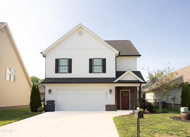 2834 Mccoy St, Kingsport, TN 37664 - view of front of property with board and batten siding, driveway, roof with shingles, a front yard, and an attached garage