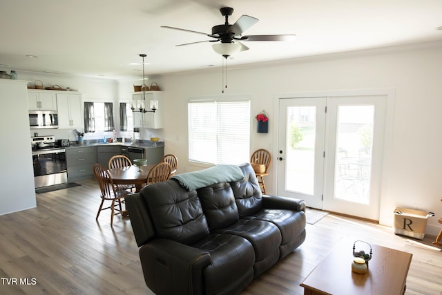 2834 Mccoy St, Kingsport, TN 37664 - living room featuring ceiling fan with notable chandelier and light wood-type flooring