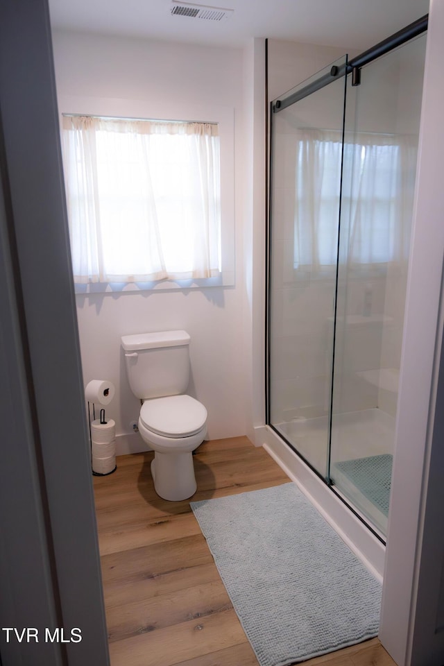 2834 Mccoy St, Kingsport, TN 37664 - bathroom featuring toilet, visible vents, wood finished floors, and a stall shower