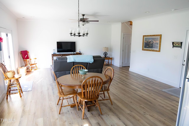 2834 Mccoy St, Kingsport, TN 37664 - dining area featuring baseboards, ceiling fan with notable chandelier, and light wood-type flooring