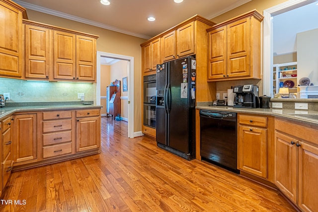 kitchen with ornamental molding, recessed lighting, tasteful backsplash, light wood-style flooring, and black appliances