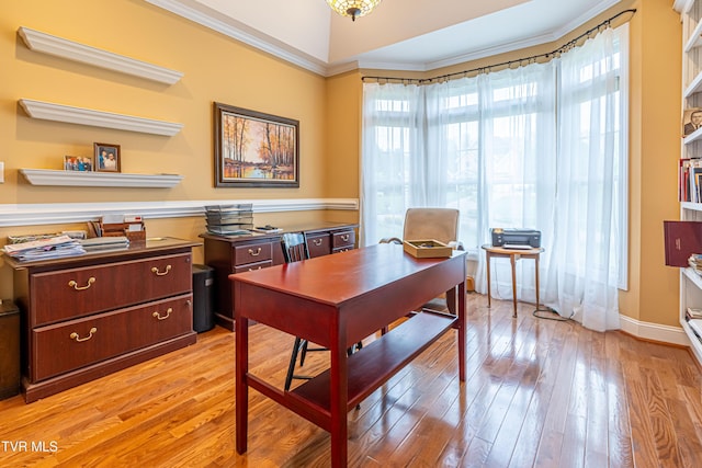home office featuring light wood-type flooring and crown molding