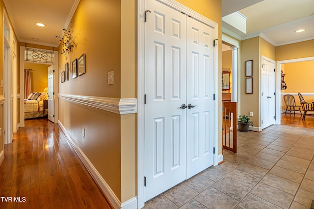 hallway with crown molding, recessed lighting, baseboards, and ornate columns