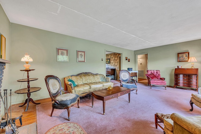living area featuring baseboards and visible vents