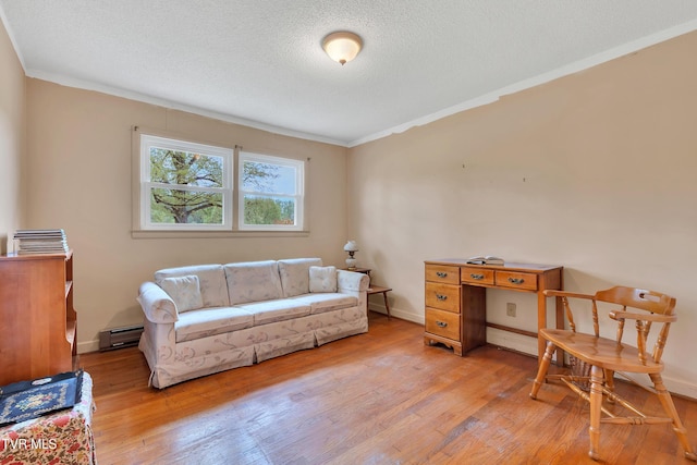 interior space with light wood-style floors, ornamental molding, and a baseboard radiator