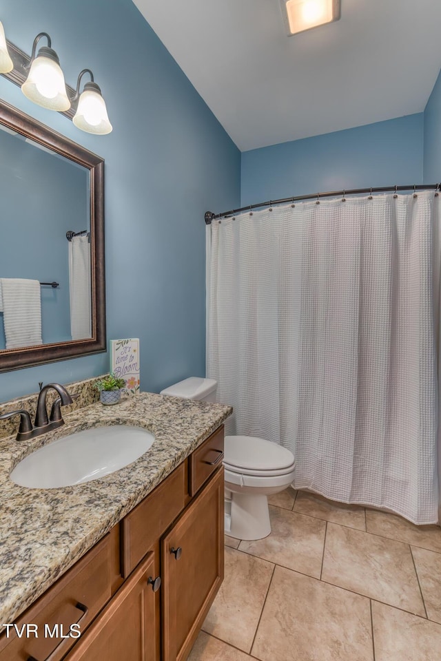 full bath with vanity, tile patterned floors, and toilet
