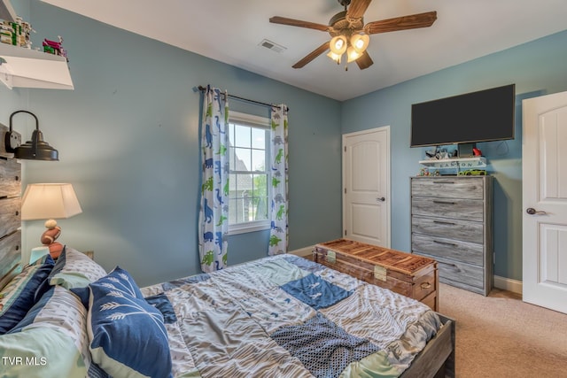 bedroom with a ceiling fan, visible vents, and light carpet