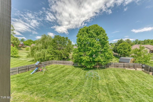 view of yard featuring a fenced backyard and a playground