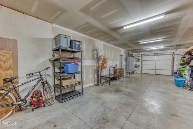 garage featuring gas water heater and concrete block wall