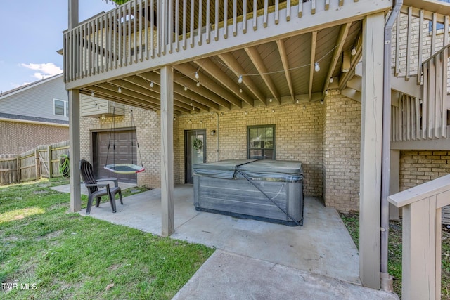 view of patio featuring a hot tub and fence