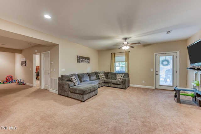 living area with carpet flooring, ceiling fan, visible vents, and baseboards