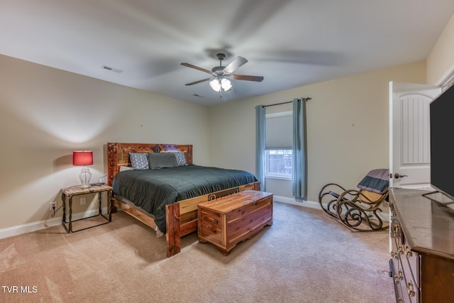 bedroom featuring light colored carpet, baseboards, visible vents, and a ceiling fan