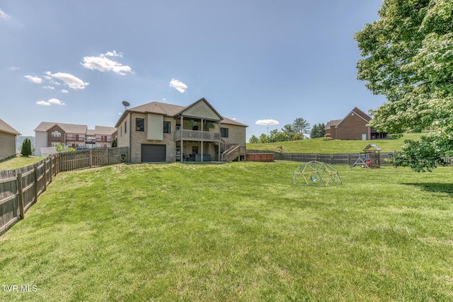back of property featuring a fenced backyard, stairs, an attached garage, and a playground