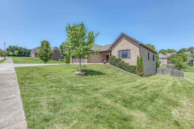 single story home featuring brick siding, a front lawn, and fence
