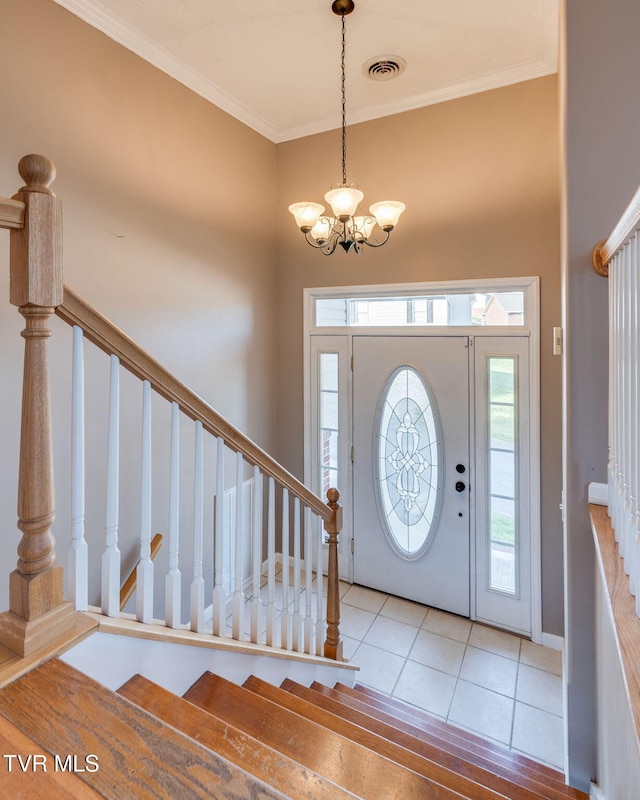 241 Stone Edge Cir, Kingsport, TN 37660 - tiled entryway featuring visible vents, stairs, crown molding, and an inviting chandelier