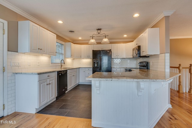 241 Stone Edge Cir, Kingsport, TN 37660 - kitchen featuring a peninsula, wood finished floors, white cabinets, light stone counters, and black appliances