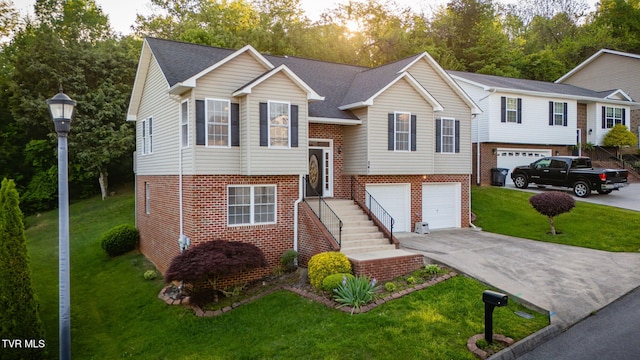 241 Stone Edge Cir, Kingsport, TN 37660 - raised ranch featuring a garage, concrete driveway, a front lawn, and brick siding