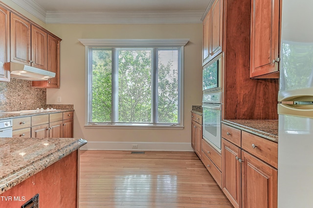 2304 Granite Dr, Johnson City, TN 37604 - kitchen featuring light stone counters, plenty of natural light, under cabinet range hood, and white appliances