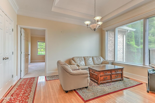 2304 Granite Dr, Johnson City, TN 37604 - living room featuring an inviting chandelier, light wood-style flooring, crown molding, and baseboards