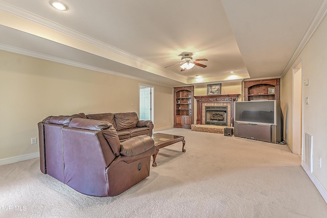 2304 Granite Dr, Johnson City, TN 37604 - carpeted living room featuring ornamental molding, a brick fireplace, baseboards, a tray ceiling, and a ceiling fan