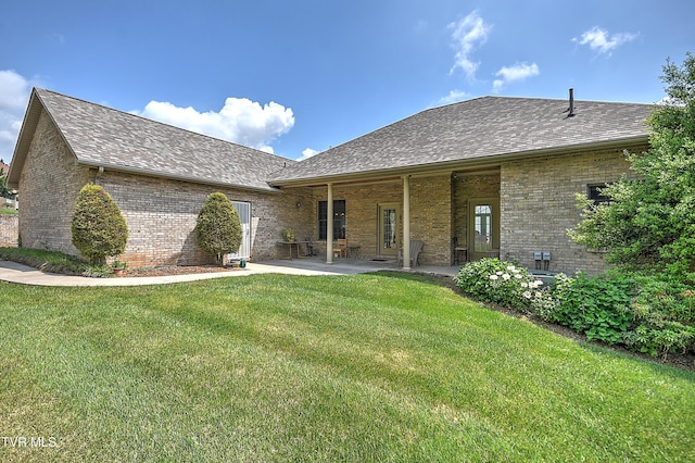 2304 Granite Dr, Johnson City, TN 37604 - back of house with brick siding, a shingled roof, a patio area, and a yard