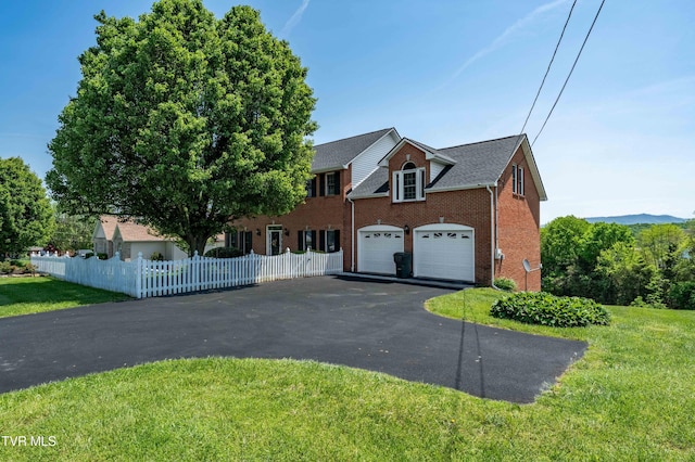 436 Headtown Rd, Jonesborough, TN 37659 - colonial-style house featuring brick siding, a front lawn, fence, and driveway