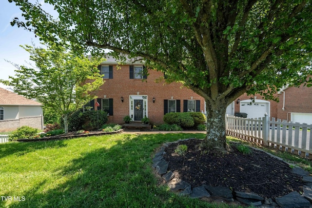 436 Headtown Rd, Jonesborough, TN 37659 - colonial inspired home featuring fence, an attached garage, brick siding, a front yard, and concrete driveway