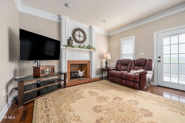 436 Headtown Rd, Jonesborough, TN 37659 - living room featuring a brick fireplace, a textured ceiling, baseboards, wood finished floors, and ornamental molding