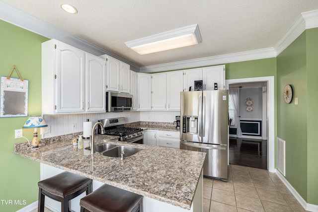 436 Headtown Rd, Jonesborough, TN 37659 - kitchen with a sink, appliances with stainless steel finishes, a peninsula, and white cabinetry