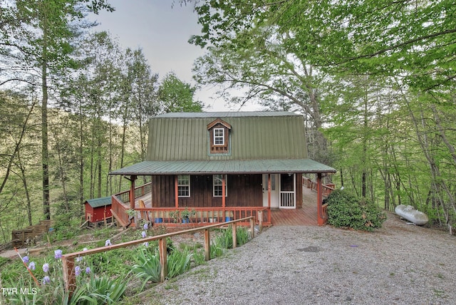 view of front of property featuring covered porch and metal roof