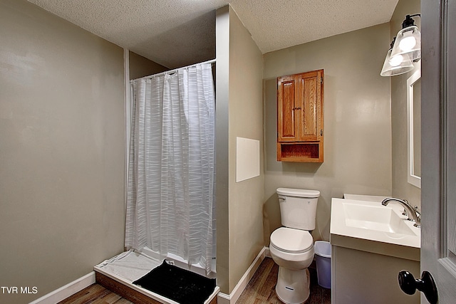 full bath with toilet, baseboards, wood finished floors, and a textured ceiling