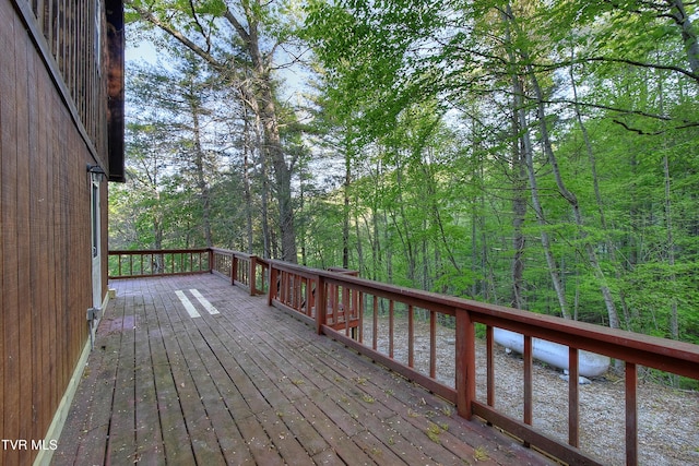 wooden terrace with a wooded view