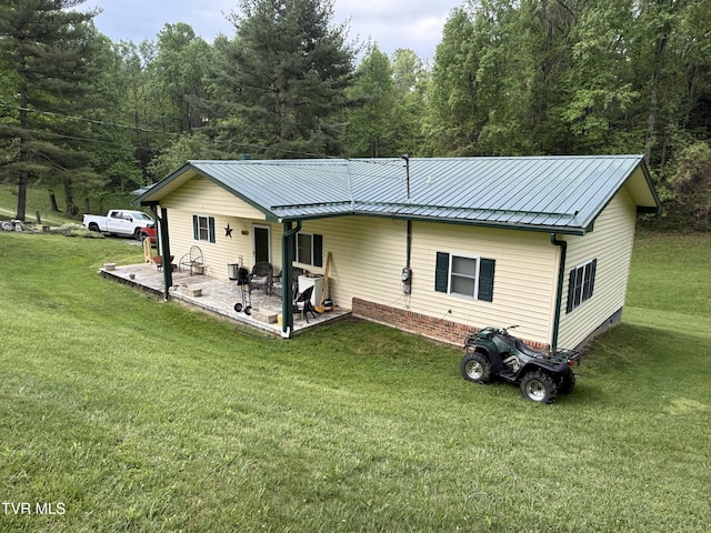 125 Babb Rd, Elizabethton, TN 37643 - rear view of house with a patio, a view of trees, a yard, and metal roof