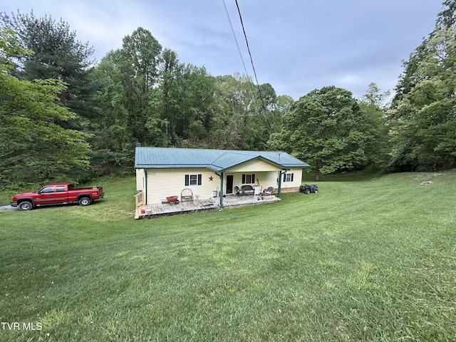 125 Babb Rd, Elizabethton, TN 37643 - back of house featuring a lawn, a view of trees, a deck, and metal roof