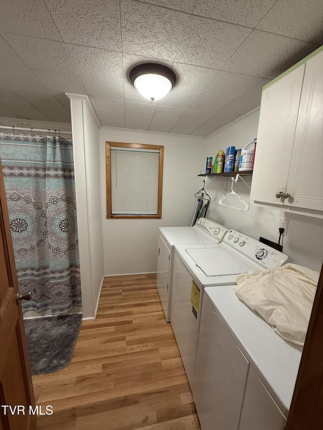 125 Babb Rd, Elizabethton, TN 37643 - laundry area featuring light wood-type flooring, washer and clothes dryer, and cabinet space