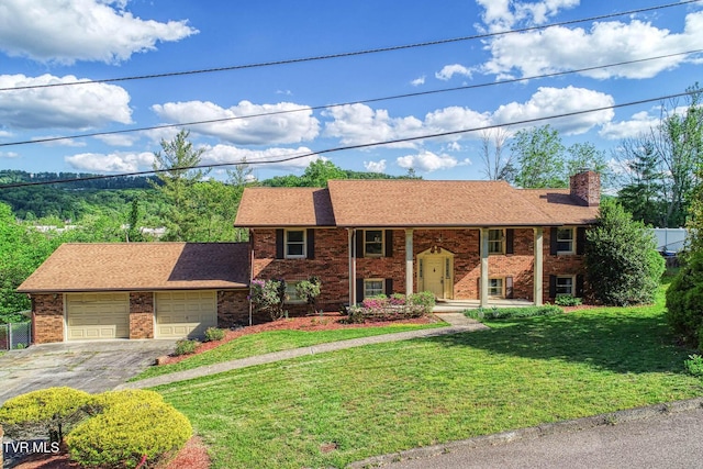 2653 Suffolk St, Kingsport, TN 37660 - bi-level home with driveway, a chimney, brick siding, a front lawn, and a shingled roof